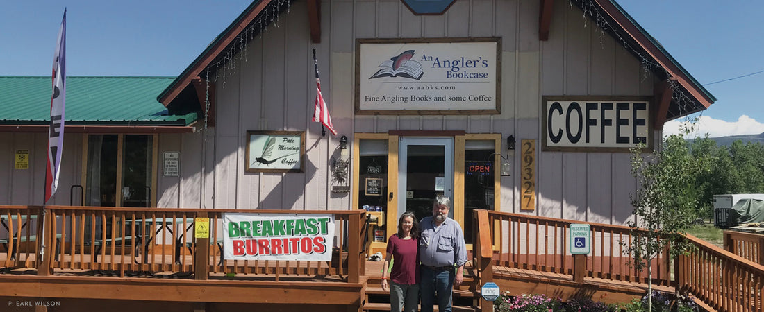 CUTBANK: AN ANGLER'S BOOKCASE. Owners and operators Craig and Catherine Douglass stand outside of An Angler’s Bookcase in South Fork, CO. Photo: Earl Wilson