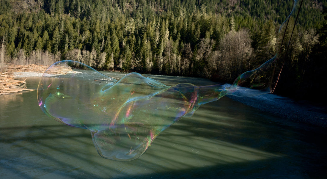 A giant soap bubble floats above a steelhead river.