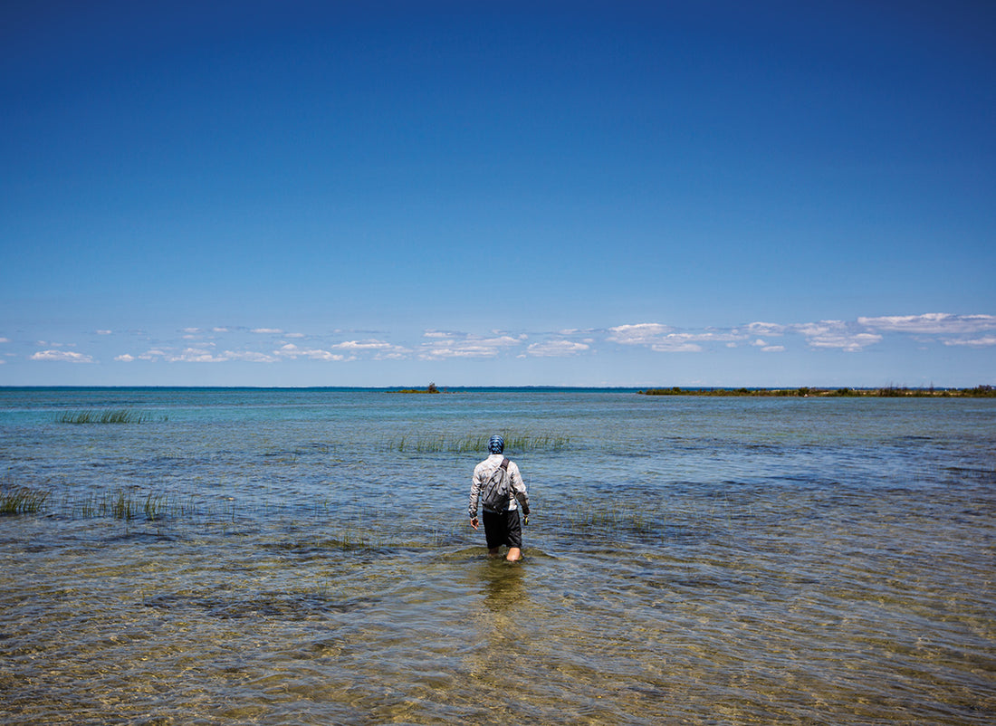 The flats of northern Lake Michigan can seem endless and lifeless. After wading and hiking for hours, Colin Flanagan stumbles upon a bay where it would all (hopefully) come together.