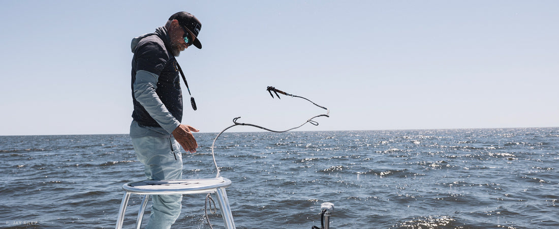 Cornhole cross training. Captain David Mangum anchors up on a tarpon swim spot in the Florida panhandle.