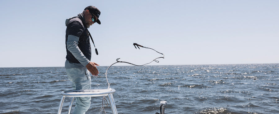 Cornhole cross training. Captain David Mangum anchors up on a tarpon swim spot in the Florida panhandle.