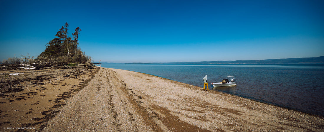 Cash East heads back to the skiff to grab lunch and a beer on an empty shoreline in Quebec’s Chaleur Bay. Photo: Joe Klementovich