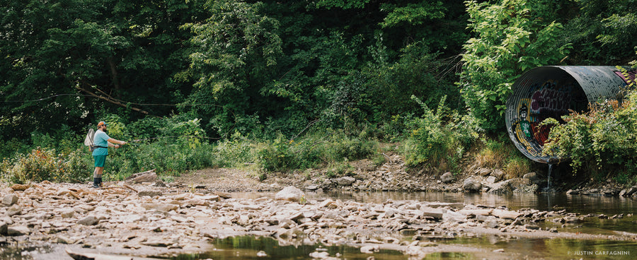 Flyfishing can take you to beautiful places, but it can also take you to the mouth of a storm drain on the Mississippi River in Minneapolis. Brandon Kelley casts a tight loop pipeward in search of the golden ticket. Photo: Justin Carfagnini