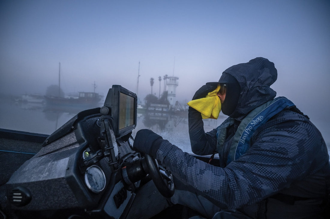 Jeremiah Houle turns on the manual windshield wipers during an early morning run in the California Delta.