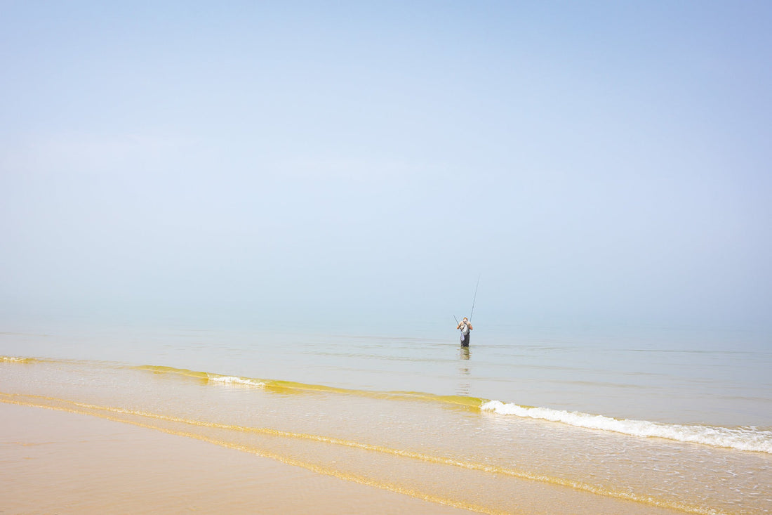 Luke Griffin looking to spot a bass cruising where the sky and ocean blend on Cape Cod’s Brewster Flats.