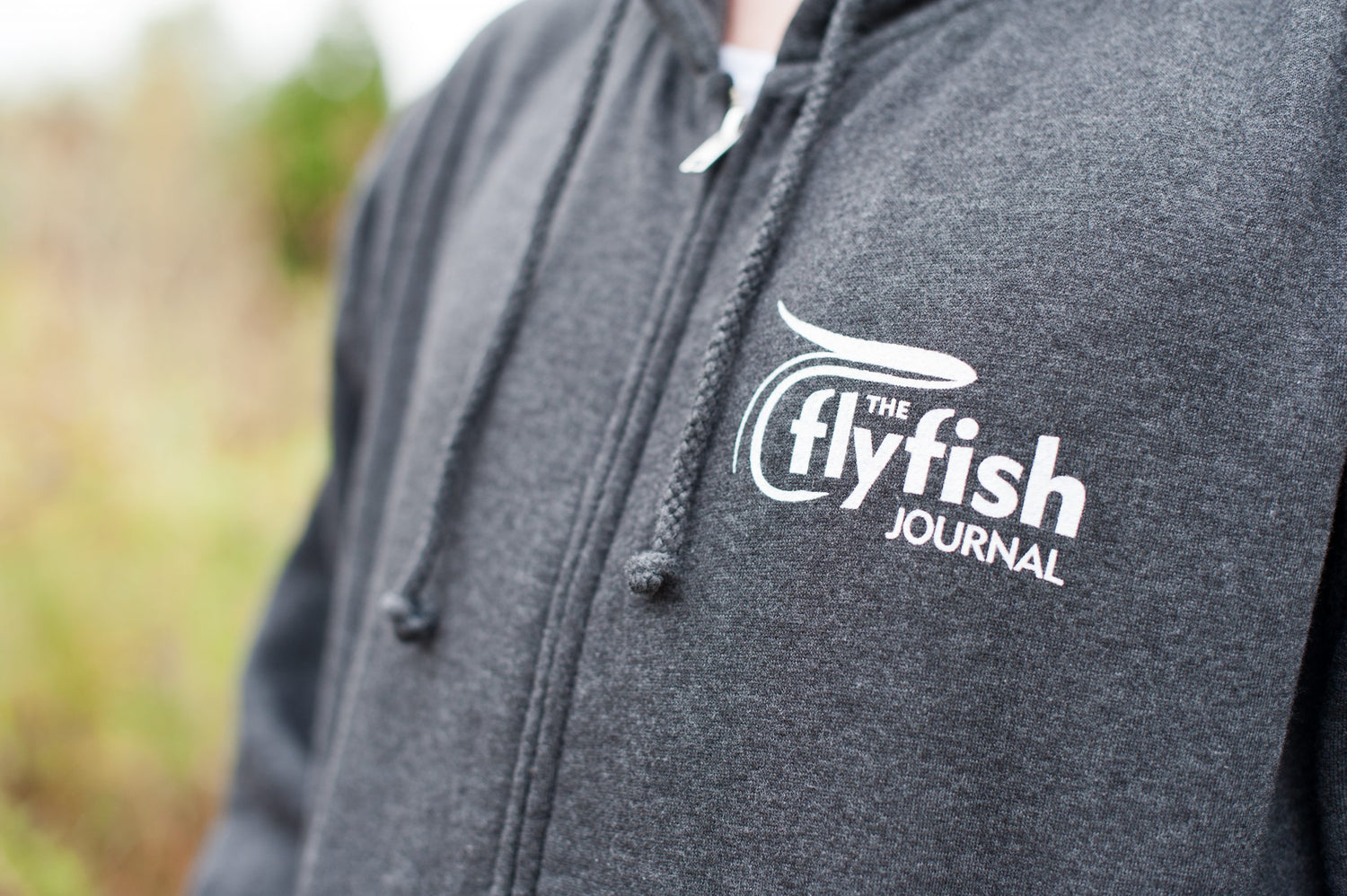 TFFJ zip hoodie logo close up view.